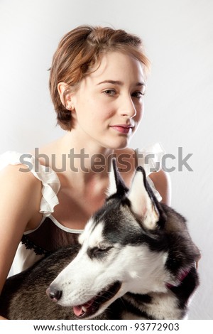 Couple sitting on the floor with their pet Husky dog