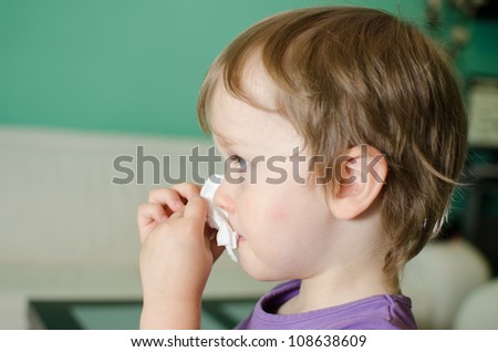 Cute kid cleaning his nose