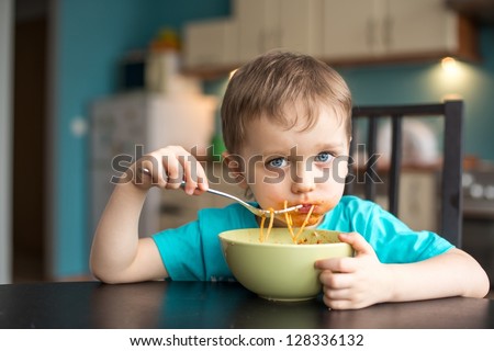 3 year old boy while eating spaghetti