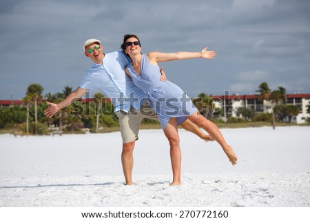 Young couple having fun at tropical beach during summer vacation, Siesta Key beach, Florida