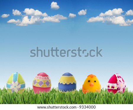 Easter eggs in grass on sky background