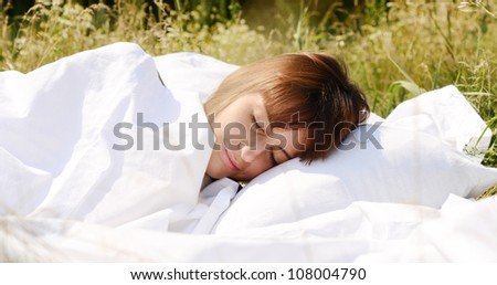 sleeping woman on green grass