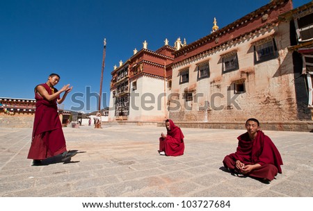 ZHONGDIAN,CHINA-APR 15: young monks debating in Songzanlin Tibetan Buddhist monastery area on April 15,2009 in Zhongdian,Yunnan China.Those who perform well have chance to become a higher lama
