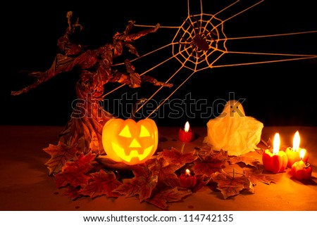 Halloween pumpkin and ghost under spooky tree