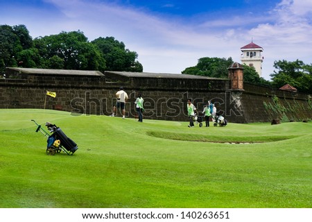 MANILA, PHILIPPINES - MAY 2 : A Group of golfers at Club Intramuros Golf Course on May 2,2012 in Intramuros district of Manila , Philippines.The golf course surrounds Intramuros's ancient wall.