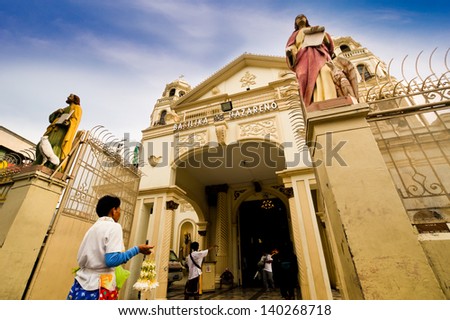 MANILA, PHILIPPINES -MAY 6: A man sell flower garland in front of the church on May 6,2012 at Quiapo Church in the center of metropolitan Manila , Philippines.