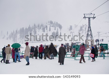GULMARG,INDIA-APRI L 13 : Asian tourists take a photo at Gulmarg on April 13,2012 in  Kashmir-India.Gulmarg is a  popular tourist destination in winter and summer.