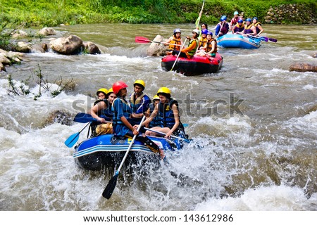 PHANG NGA,THAILAND-DEC 6:Group of tourists enjoy white water rafting on river at Song prack village on December 6,2011 in Phang nga Thailand.Here is the most popular rafting point in South of Thiland.