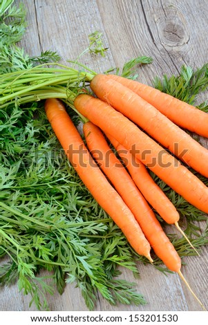 fresh and colorful natural carrots on wooden table