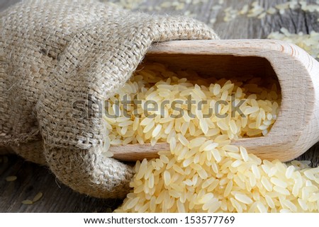 polished rice in bag ideal for salads and spade on wooden table