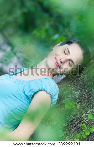 Closeup of a young woman day-dreaming