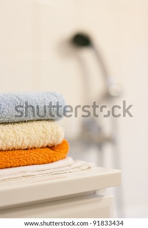 Bathroom interior: closeup of towels folded up on a bathroom cabinet