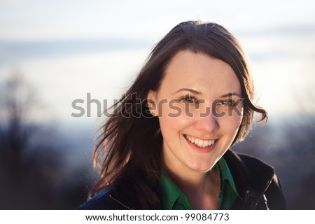Sunset portrait of a pretty confident young woman