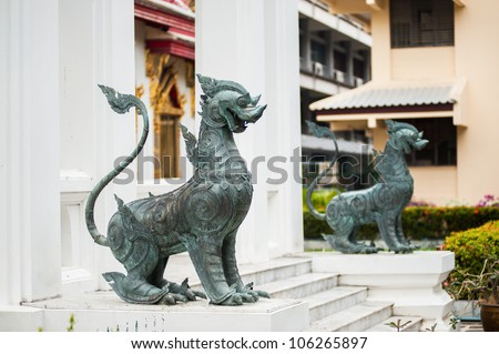 Two metal security dogs in buddhistic temple of Thailand, Bangkok.