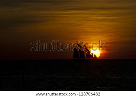 Salboat illuminated by setting sun, Mallory Square, Key West, Florida, United States