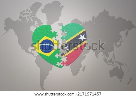 puzzle heart with the national flag of brazil and saint kitts and nevis on a world map background.Concept. 3D illustration Foto stock © 
