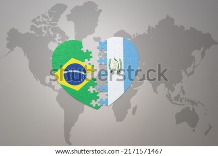puzzle heart with the national flag of brazil and guatemala on a world map background.Concept. 3D illustration Foto stock © 