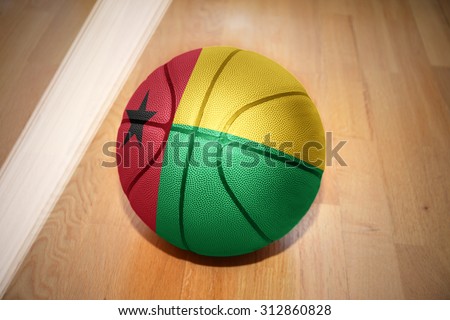 basketball ball with the national flag of guinea bissau lying on the floor near the white line