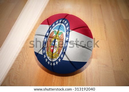 basketball ball with the flag of missouri state lying on the floor near the white line