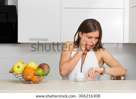 Beautiful woman having coffee and fruits for breakfast