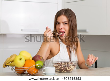 Beautiful woman having coffee and fruits for breakfast