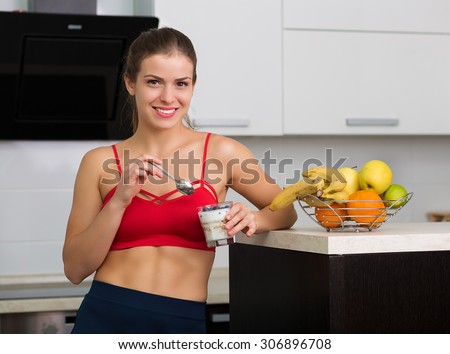 Beautiful woman having oatmeal with berries for breakfast