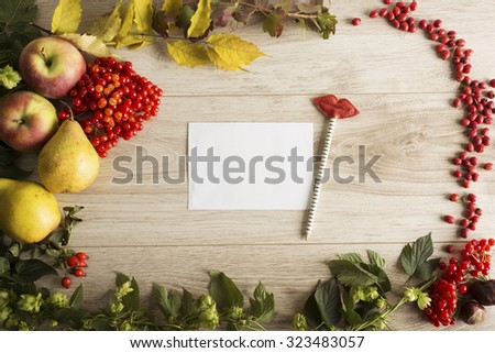 Fruits, berries and a letter on the autumn background