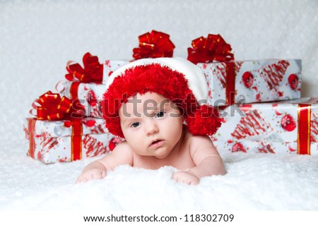 Newborn baby boy Santa Claus with Christmas gifts
