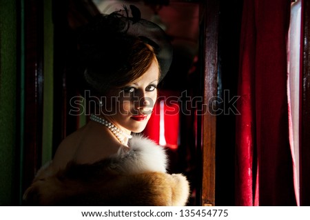 Retro Woman in hat with veil and fox furs