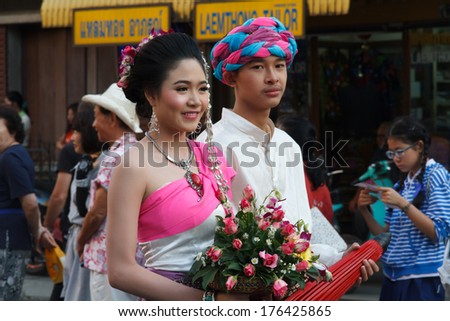 CHIANGMAI, THAILAND - FEBRUARY 8 : People march in celebration in Gate Tapae in Chiang Mai Flower Festival on February 8, 2014 in Chiang Mai, Thailand.