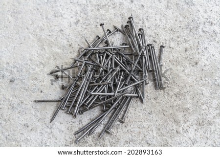Many nails for construction on cement texture.