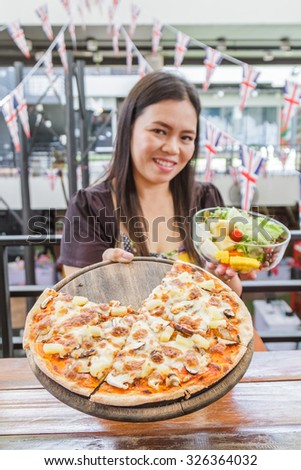 Asia girl choice food pizza or salad in restaurant