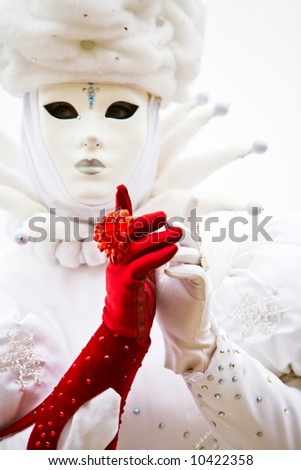 A lady in a white costume and one red glove at the Venice Carnival