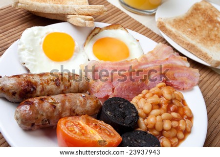 Traditional English breakfast - egg, sausages, beans, bacon and black pudding with toast