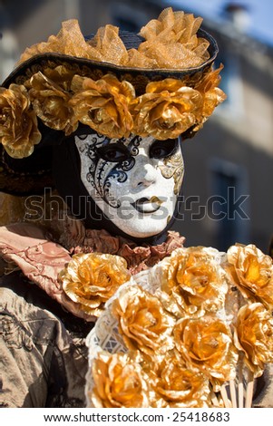 Gold costume with golden roses at the Venice Carnival