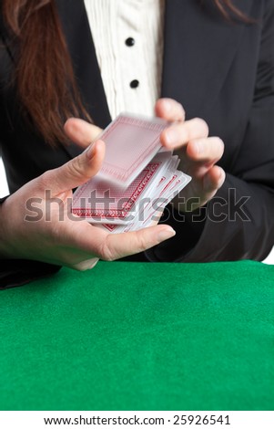 Croupier shuffling cards with motion blur on the top card