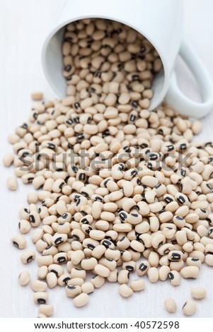 Dried black eye beans in a white cup
