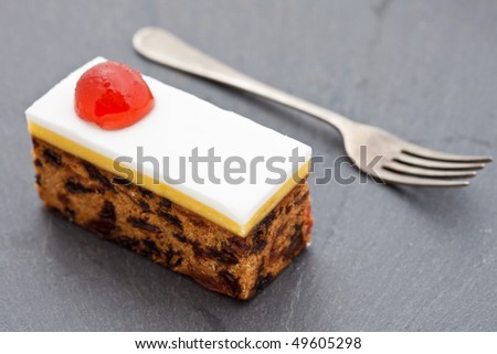 Slice of fruit Christmas cake with a fork