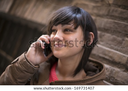 Beautiful young woman talks on the telephone