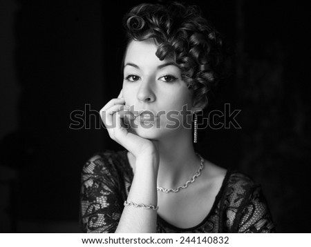 Beautiful young woman portrait. Jewelry and diamonds. Image on black and white.