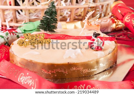 Traditional Christmas fruit cake with hamper basket at the background