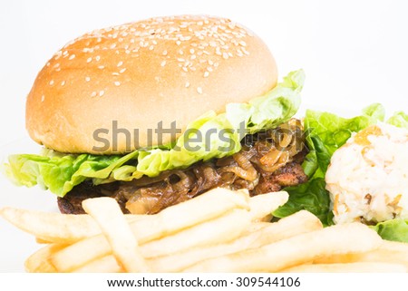 Grilled Chicken Burger with caramelized onions served with french fries and coleslaw