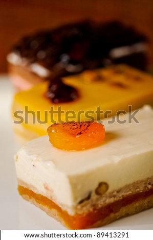 Three assorted cakes slices on a white plate
