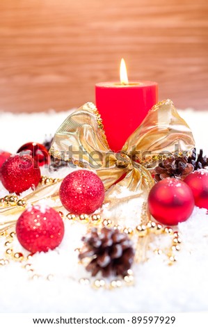 Red Christmas  theme on snow with wood background and gold christmas ornaments