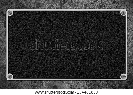 black leather background in silver metal frame on rough pattern iron texture