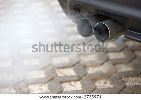 Double-Pipe-Exhaust of a car. Much Dust...