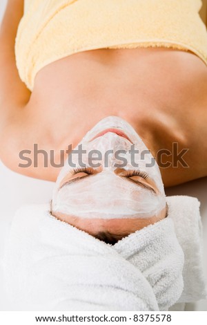 Wellness - woman from behind. Sleeping with facemask and towels.