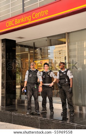 TORONTO-JUNE 25: Security service personnel in front of CIBC Bank at G20 protest on June 25, 2010 in Toronto, Canada.