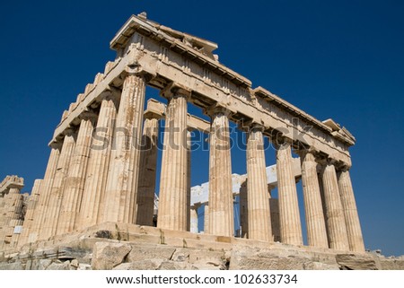 The ancient temple of Parthenon on the Acropolis of Athens, Greece, with deep blue sky behind.