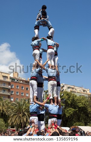 BARCELONA, SPAIN - APRIL 21: Catalan human pyramid (Castell) performed by the Castellers of Poble Sec in the festival of La Sagrada Familia on April 21, 2013 in Barcelona, Spain.